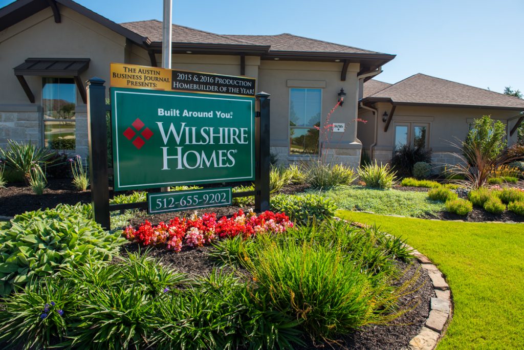 Wilshire Homes sign with Austin Business Journal Production Homebuilder of the Year award