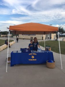 Mother and son selling merch for the Lago Vista Vikings.