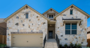 New home with stone facade by Coventry Homes in Lakeside at Tessera on Lake Travis.