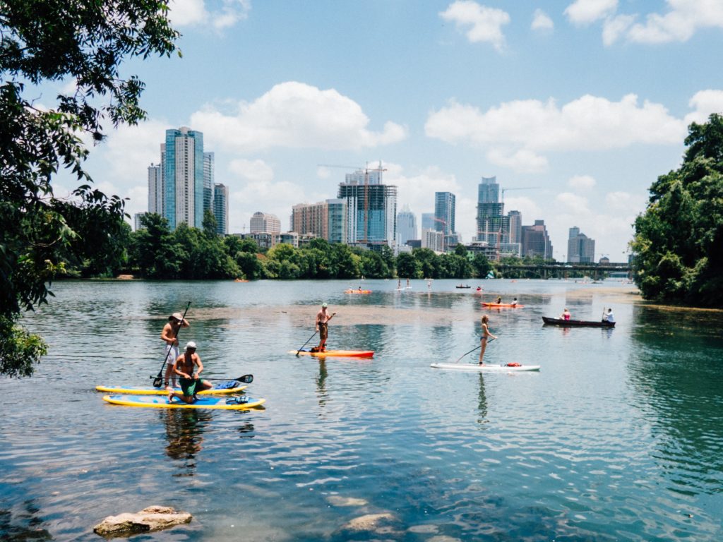 People paddleboarding in the hot Austin summer weather.