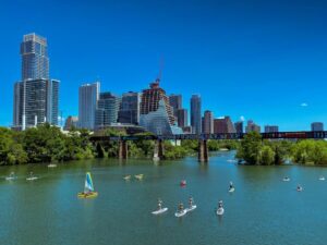 Summertime on Lady Bird Lake with the downtown Austin, Texas city skyline in the background.